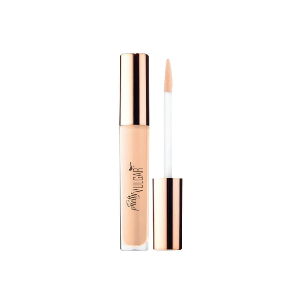 Under Cover Concealer | Pretty Vulgar with a sleek rose gold cap and applicator wand, shown in a light beige shade for flawless skincare coverage.