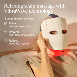 Person wearing a Theraface Mask Glo | Therabody delivering a relaxing scalp massage with VibraWave technology and customizable settings for relaxation, energy, and relief.