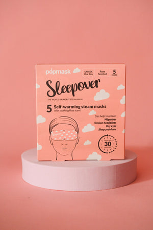 Sleepover Self Warming Steam Mask | Popmask package in soft pink with rose scent, designed for skincare and wellness to relieve migraines, tension headaches, dry eyes, and sleep problems.