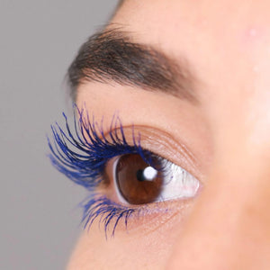 Close-up of an eye with long, vibrant blue lashes showcasing the effect of Good Drama Mascara | Chella, enhancing natural brown eyes with bold color.