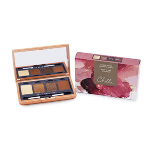 Open Manifest Bronze Eyeshadow Palette | Chella displaying five warm bronze and neutral shades with applicator brush next to its artistic pink and gold marbled packaging.
