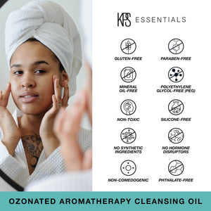 Woman with a towel wrapped around her head applying Ozonated Aromatherapy Cleansing Oil | Kindness Powered Skincare, alongside icons indicating the product is gluten-free, paraben-free, mineral oil-free, PEG-free, non-toxic, silicone-free, free of synthet