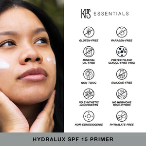 Woman applying Hydralux SPF 15 Primer | Kindness Powered Skincare with visible icons highlighting the product’s gluten-free, paraben-free, mineral oil-free, PEG-free, non-toxic, silicone-free, no synthetic ingredients, no hormone disruptors, non-comedogen