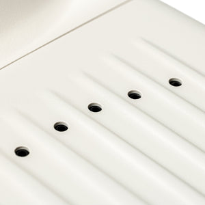 Close-up of a white panel with multiple small black openings designed as part of the SUMSEI Air Shower | SUMSEI, a wellness device for improved skincare and body care routines.