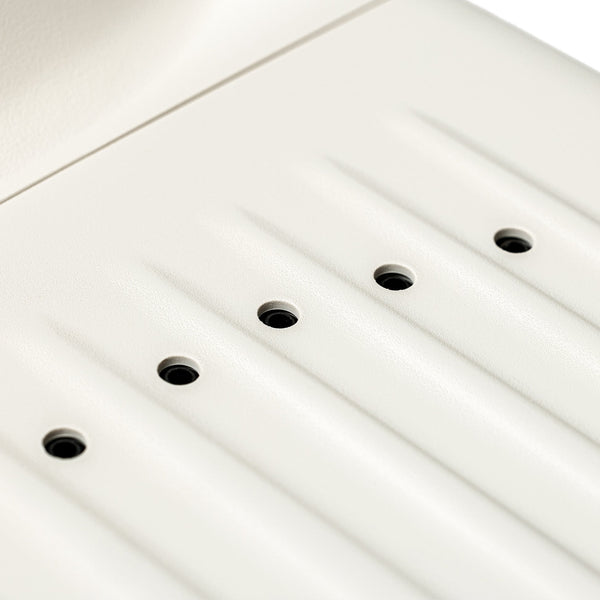 Close-up of a white panel with multiple small black openings designed as part of the SUMSEI Air Shower | SUMSEI, a wellness device for improved skincare and body care routines.