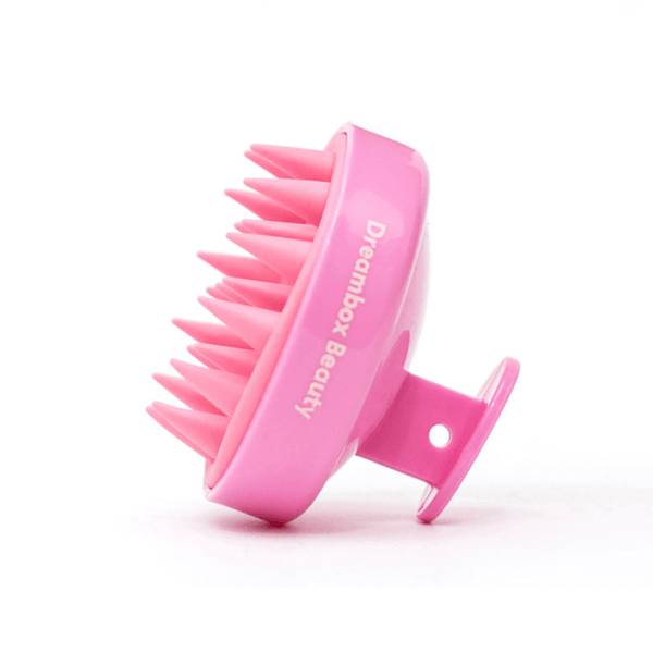 Pink silicone scalp scrubber with soft flexible bristles and ergonomic handle, designed for gentle scalp massage and cleansing by Scalp Scrubber [Revitalizing Scalp Massager] | Dreambox Beauty.