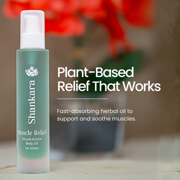 Bottle of Muscle Relief Oil | Shankara with white pump dispenser, standing on a wooden surface with blurred red flowers in the background, promoting plant-based muscle and joint relief.