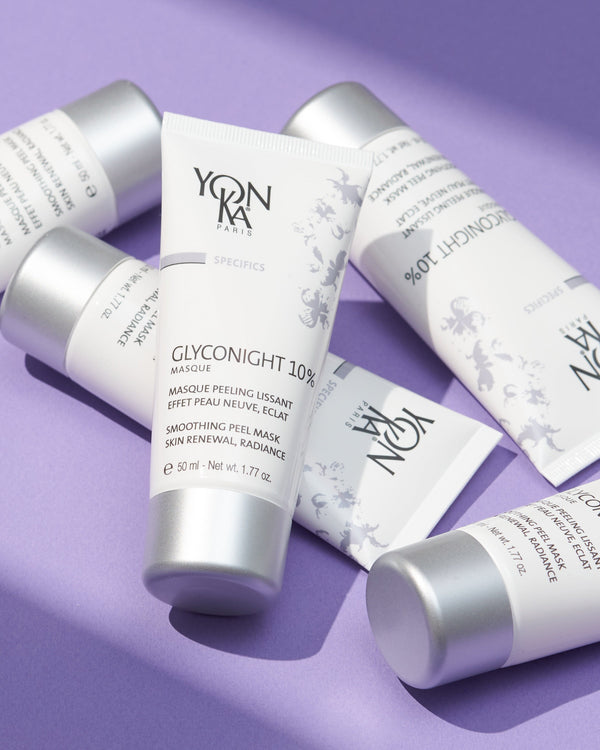 GlycoNight 10% Peel Masque | Yon-Ka Paris skincare product tubes arranged on a lavender surface, highlighting the smoothing peel mask for skin renewal and radiance.