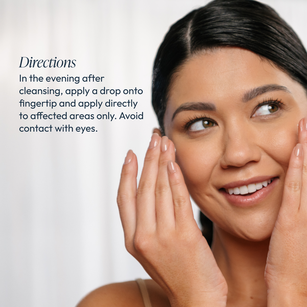 A smiling woman gently applies Radiant Brightening Serum (Formerly Bright White Serum) | Circadia to her face with her fingertip, demonstrating evening skincare application after cleansing.