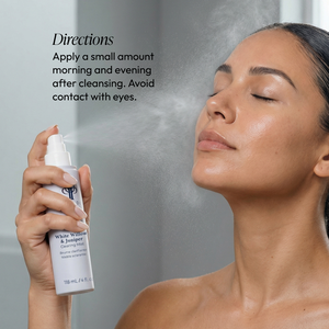 A woman with clear skin sprays White Willow & Juniper Clearing Mist | Circadia onto her face, demonstrating its use for skincare with directions in the background.