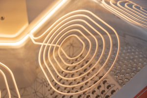Close-up view of glowing heating elements inside a wellness device designed for relaxation and recovery, highlighting the smooth curved lines and warm light of the Ammortal Chamber | Ammortal.