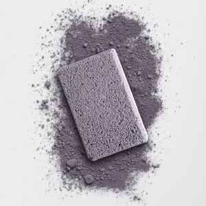 In The Buff Dual-Texture Siliglass Pumice Stone | Barefoot Scientist shown on a textured gray surface, highlighting its exfoliating and skincare benefits for body care and wellness.