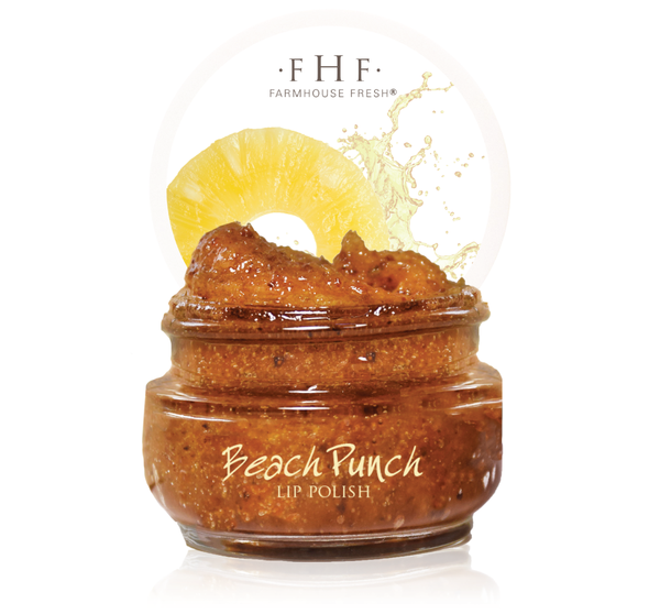 Open jar of Beach Punch® Lip Polish | Farmhouse Fresh with a textured, brown scrub inside and a slice of pineapple and splash graphic in the background.