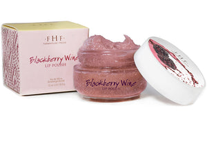 Blackberry Wine Lip Polish | Farmhouse Fresh in a clear jar with textured pink lip polish and a white lid with blackberry artwork, alongside its matching pink box packaging.