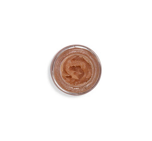 Top view of an open jar filled with a shimmering lip polish in a warm berry shade, showcasing the glossy texture of Blackberry Wine Lip Polish | Farmhouse Fresh.