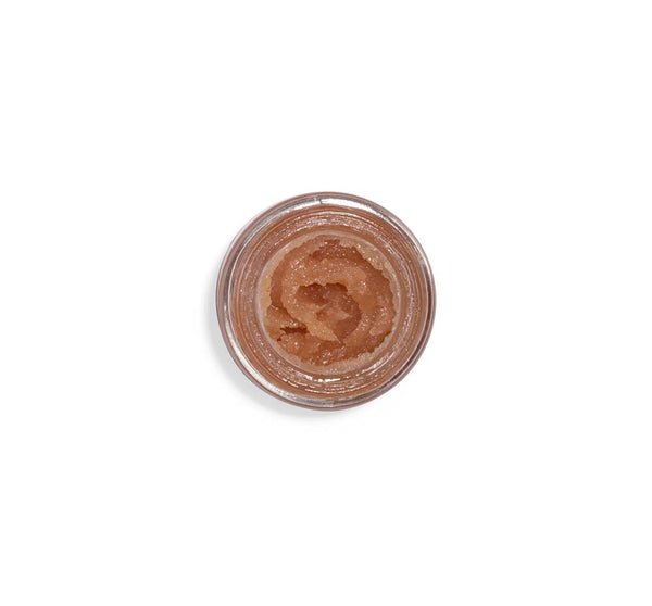 Top view of an open jar filled with a shimmering lip polish in a warm berry shade, showcasing the glossy texture of Blackberry Wine Lip Polish | Farmhouse Fresh.