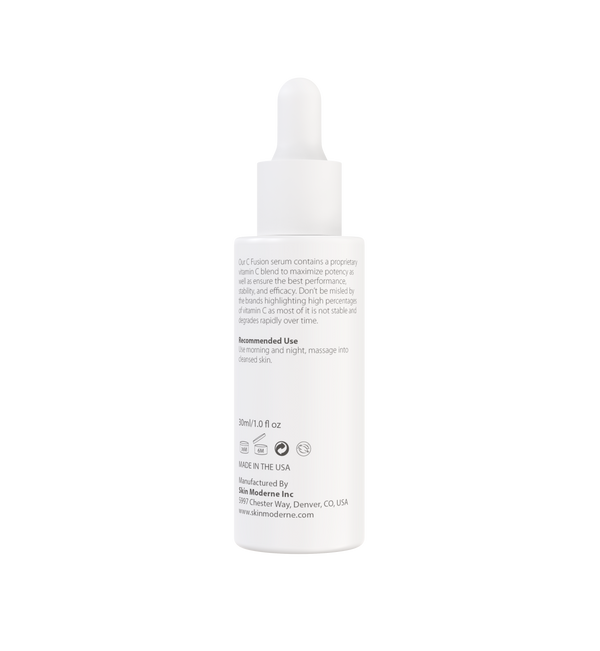 White dropper bottle of C Fusion | Skin Moderne serum with text describing vitamin C blend, recommended use, and manufacturing details visible on label.