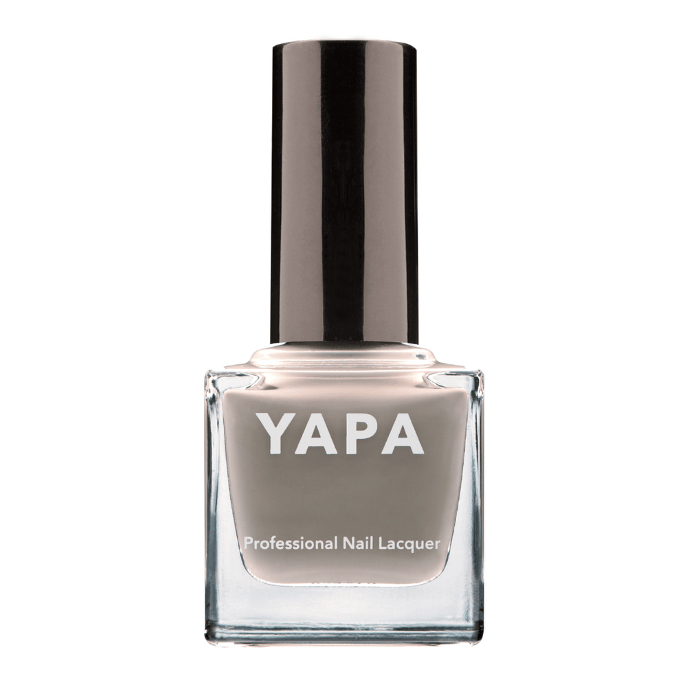 Charlotte Nail Lacquer | YAPA in a sleek glass bottle featuring a muted taupe shade of professional nail lacquer with a black cap for a polished manicure look.