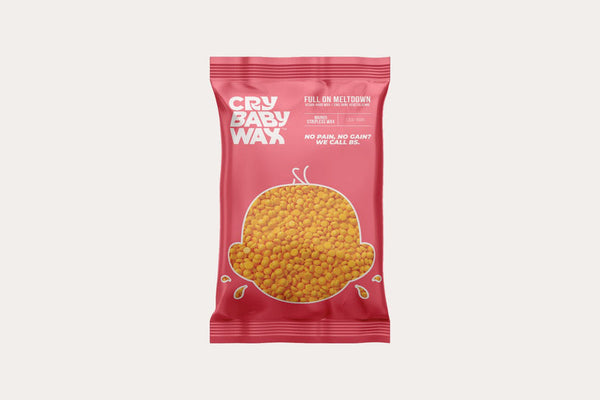 Red packaging of Full On Meltdown Vegan Hard Wax | Crybaby Wax showing small yellow wax pellets inside and branding text on front for skincare and body care use.