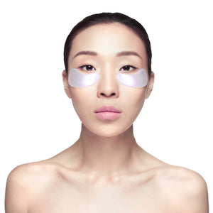 Young woman with smooth skin wearing iridescent eye masks under her eyes, promoting skincare and wellness with Diamond Radiance Eye Mask - 6 pack | Knesko.