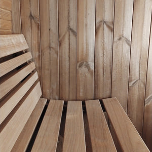 Closeup of wooden bench seating inside the E6 Sauna Barrel - 2-4 Person | Western Sol, showcasing smooth natural wood planks designed for comfortable wellness and relaxation.