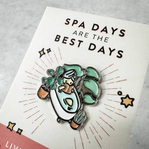 Fab Spa Life Enamel Pin - Limited Edition | Lucky Owl depicting a relaxing bathtub scene with plants and spa elements, emphasizing wellness and self-care.