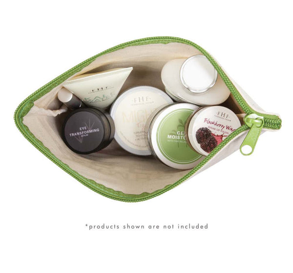 Open top view of FHF Canvas Cosmetic Bag | Farmhouse Fresh filled with assorted skincare and body care products inside against a white background.