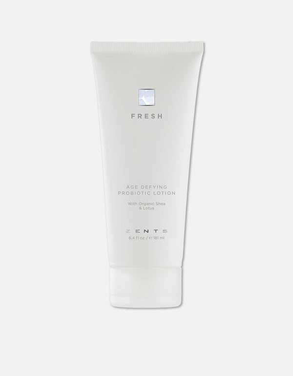 White tube of Age Defying Probiotic Lotion | Zents with minimalist design, featuring organic shea and lotus for skincare and wellness.