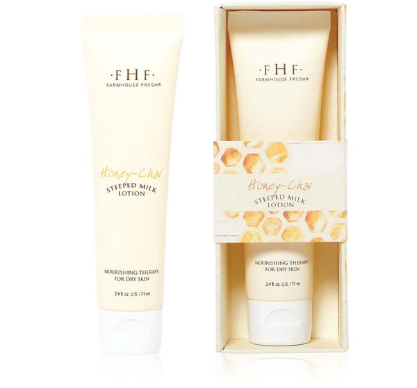 Two tubes of Honey-Chai Steeped Milk Lotion® for Hands | Farmhouse Fresh, one standing alone and the other in a decorative box, showcasing skincare and body care packaging.