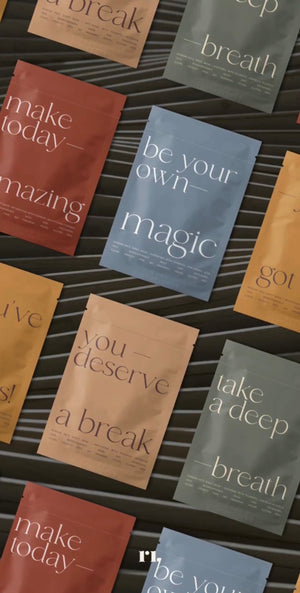 Flat lay of colorful skincare sheet mask packets with motivational phrases, featuring Korean Sheet Mask - You've Got This | Lucky Owl for wellness and self-care.