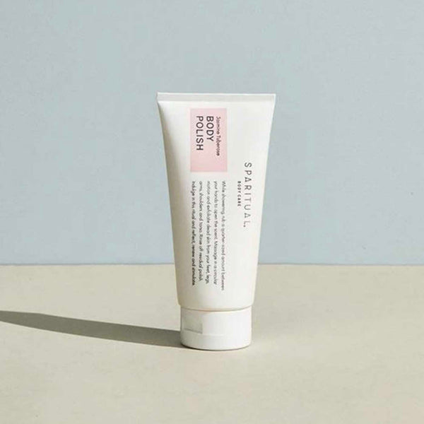 Tube of Jasmine Tuberose BODY POLISH | Sparitual skincare product standing on a flat surface with a soft neutral background, highlighting body care and wellness.