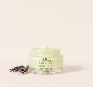 Jar of Mighty Brighty™ Vitamin C + Licorice Root Brightening Sleep Gelée | Farmhouse Fresh with soft green cream and sprigs of lavender on a neutral background, skincare product.