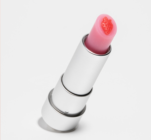 Strawberry Mood Fruit™ Lip Therapy | Farmhouse Fresh lip balm in silver tube with pink balm and small red strawberry detail on top, skincare essential for lip care.