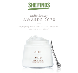 Glass jar of Moon Dip Back To Youth Ageless Body Mousse | Farmhouse Fresh with a small silver spatula, featured in She Finds Indie Beauty Awards 2020 with creamy white body care mousse visible.