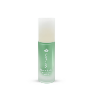 Green frosted glass bottle of Muscle Relief Oil | Shankara with a white cap, designed for muscle and joint body care and wellness.