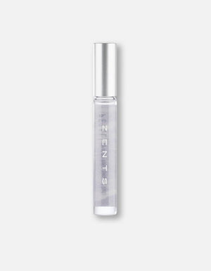 Clear glass roll-on bottle with silver cap containing a light purple fragrance labeled Attar Roll-on Scent | Zents for personal wellness and body care.