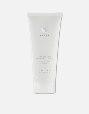 White tube of Age Defying Probiotic Lotion | Zents with organic shea and lotus extract, designed for skincare and body care wellness.