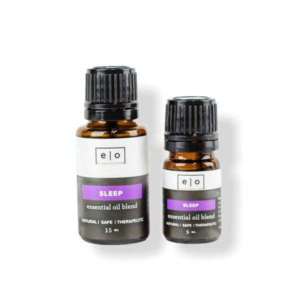 Two amber glass bottles with black caps containing "Essential Oil Blends | Essence One" sleep essential oil blend, labeled as natural, safe, and therapeutic in 15 ml and 5 ml sizes.