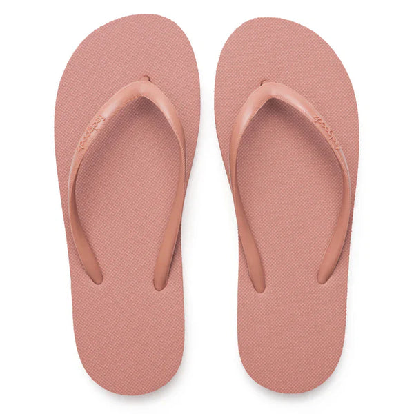 A pair of slim, minimalist pink sandals with textured soles and simple straps, designed for comfortable casual wear, labeled Slimz Core Sandals | Feelgoodz.