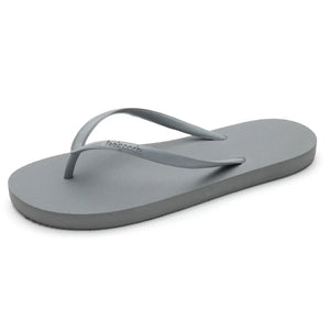 Single light gray flip flop sandal with thin straps, designed for casual wear, showcasing the Slimz Core Sandals | Feelgoodz style.
