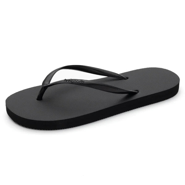 Black minimalist flip-flop sandal with thin straps designed for casual comfort, featuring the Slimz Core Sandals | Feelgoodz branding.