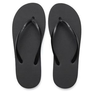 Pair of simple black flip-flop sandals with textured sole and thin straps, designed for casual comfort and style, titled Slimz Core Sandals | Feelgoodz.