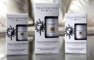 Three sizes of Travertine Body & Spirit steam shower spray bottles in packaging, featuring Eucalyptus + Lavender Steam Shower Spray | Travertine Spa for aromatherapy and wellness.