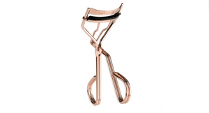 Procurl Lash Curler | Tweezerman in a polished rose gold finish, designed for precise eyelash curling with comfortable grip handles and a cushioned curling pad.