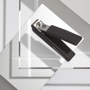 Precision Grip Toenail Clipper | Tweezerman with textured black handles designed for comfortable, precise toenail grooming, displayed on a clean, modern surface.