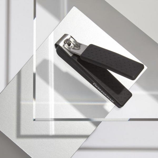 Precision Grip Toenail Clipper | Tweezerman with textured black handles designed for comfortable, precise toenail grooming, displayed on a clean, modern surface.