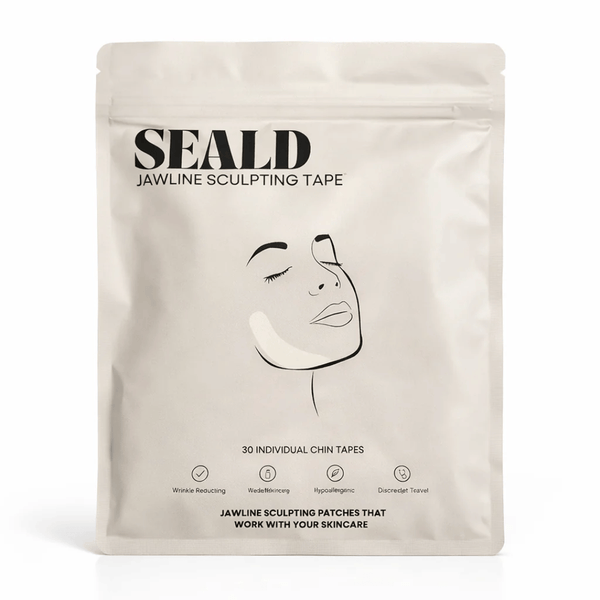 Minimalist beige packaging of Jawline Sculpting Patches | Seald™ Wellness featuring a simple line drawing of a woman's face with a patch applied to the chin area for skincare and facial contouring.