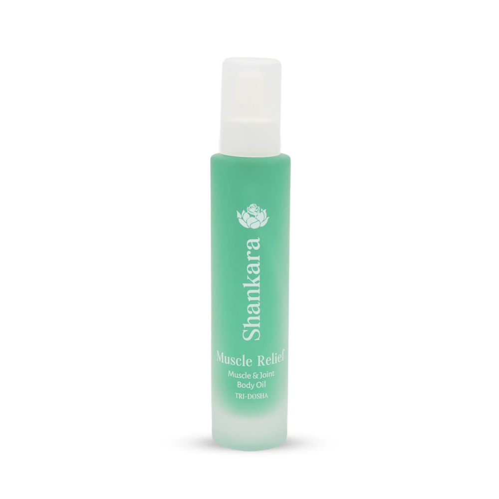 A green frosted glass bottle of Muscle Relief Oil | Shankara, designed for muscle and joint body care, featuring a white spray cap and minimalist text branding.