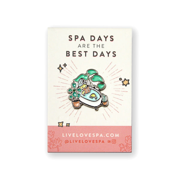 Fab Spa Life Enamel Pin - Limited Edition | Lucky Owl displayed on a card reading "Spa days are the best days," featuring a colorful spa scene with plants and a bath.