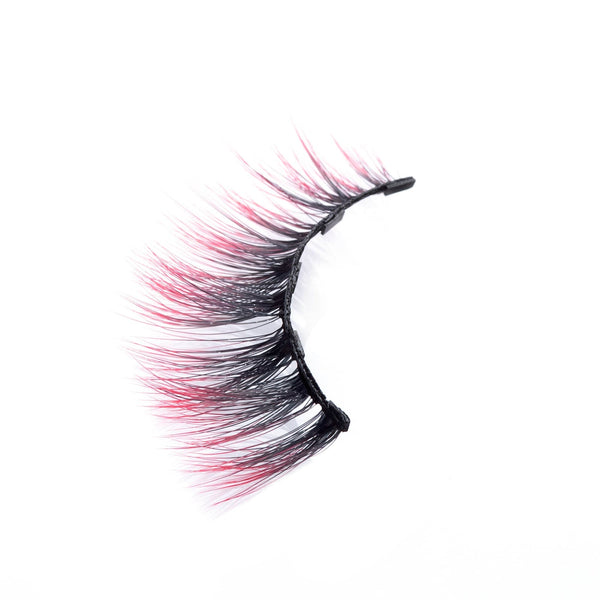 Close-up of a single false eyelash with black roots fading into pink tips, styled to enhance eye appearance, showcasing Sunny Lash - Colored | Moxielash.